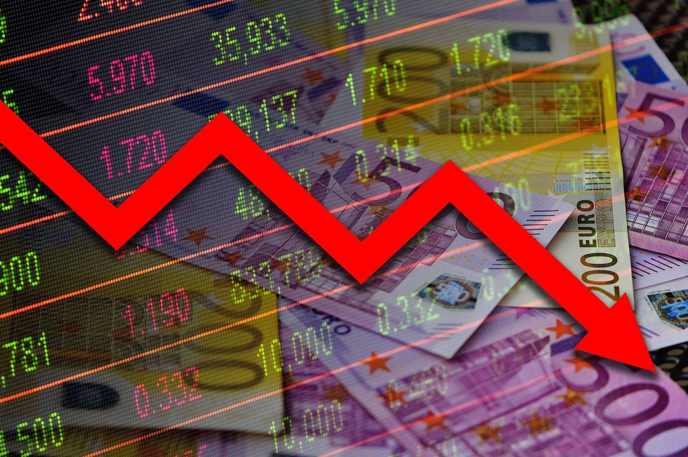Economy graph pointing down with Euro banknotes behind it