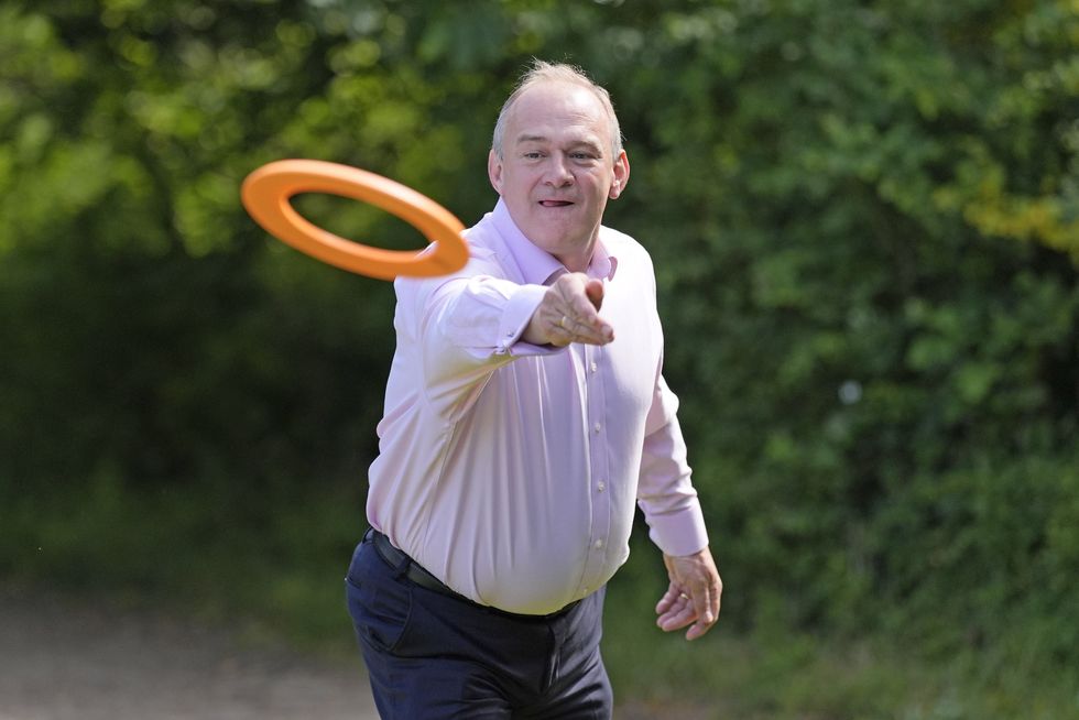 Ed Davey plays with a frisbee during a visit to Hampshire