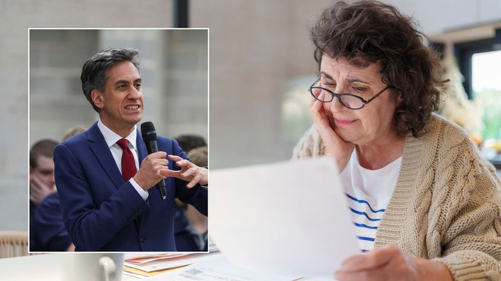 Ed Miliband and older woman looking at energy bill
