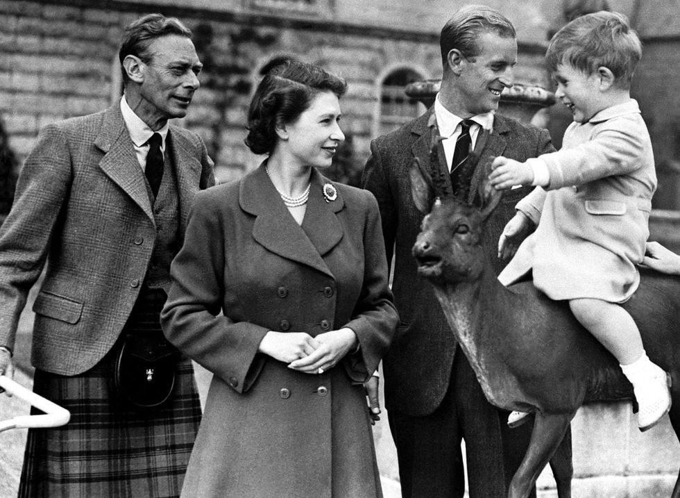 EDITORIAL USE ONLY - NO SALES -MANDATORY CREDIT REQUIRED Undated handout file photo issued by Buckingham Palace of the Queen with her father, King George VI, and Prince Philip watching a young Prince Charles sitting on a statue at Balmoral in 1951, posted on the royal family Twitter feed to mark Father's Day. Issue date: Sunday June 20, 2021.