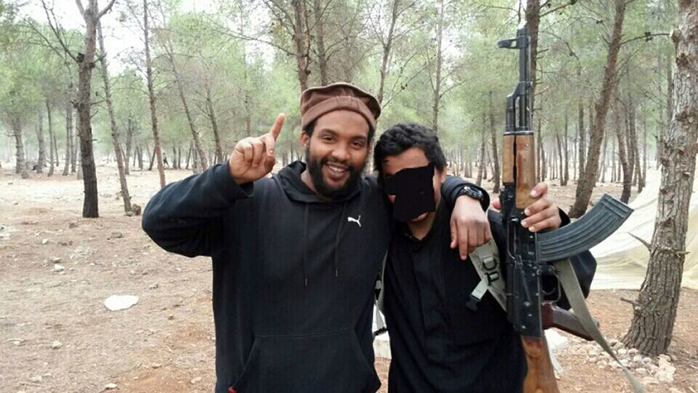 EDITORS NOTE: IMAGE OBSCURRED AT SOURCE FILE PHOTO: Undated Metropolitan Police handout file photo of Aine Davis (left) issued after his wife Amal El-Wahabi was found guilty in 2014 of funding jihadists in Syria. Aine Leslie Davis, 38, alleged to be the fourth member of a terror cell known as The Beatles, was arrested at Luton Airport on Wednesday evening after being deported to England by Turkish authorities. He has been charged with terrorism offences in 2014 and possession of a firearm for a purpose connected with terrorism and will appear at Westminster Magistrates' Court later today. Issue date: Thursday August 11, 2022.