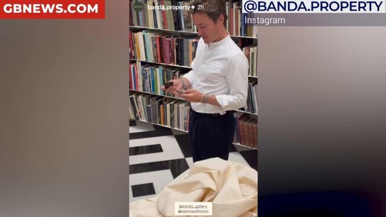 Princess Beatrice's husband Edoardo examines his own business cards in bizarre promo