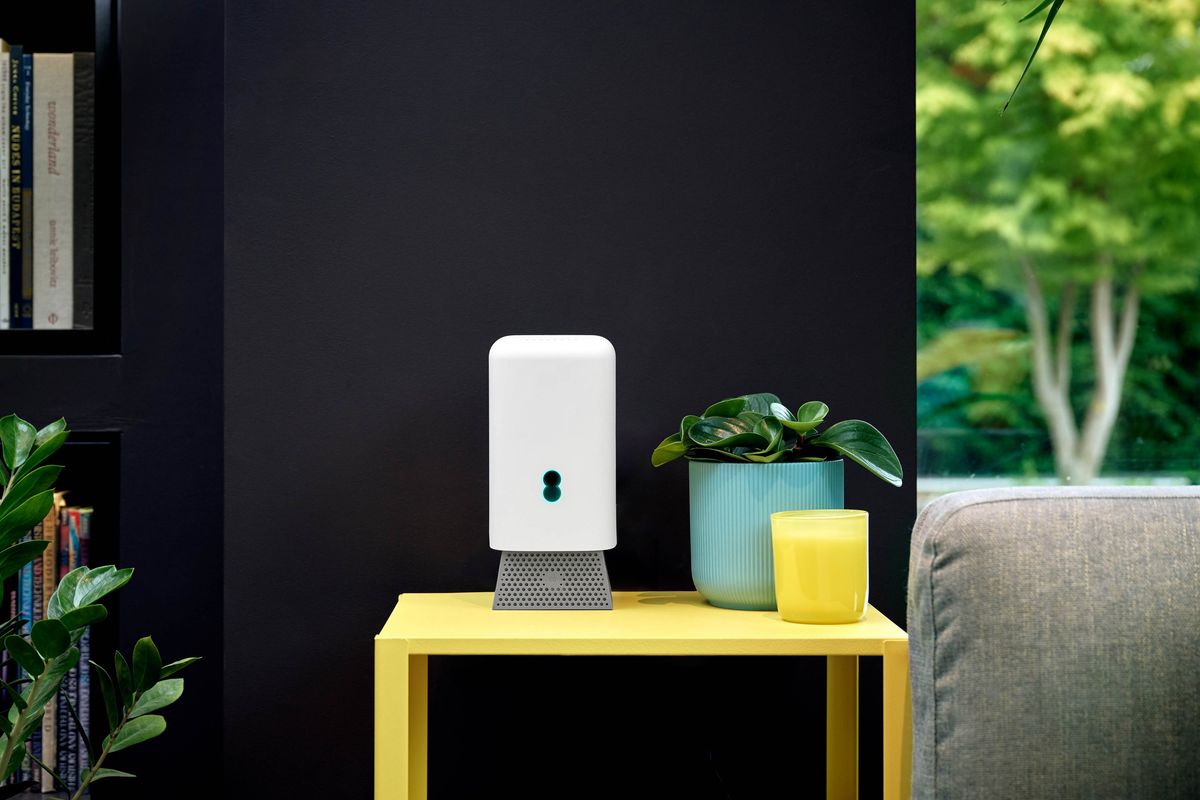 EE Smart Hub 7 Pro pictured on a yellow table