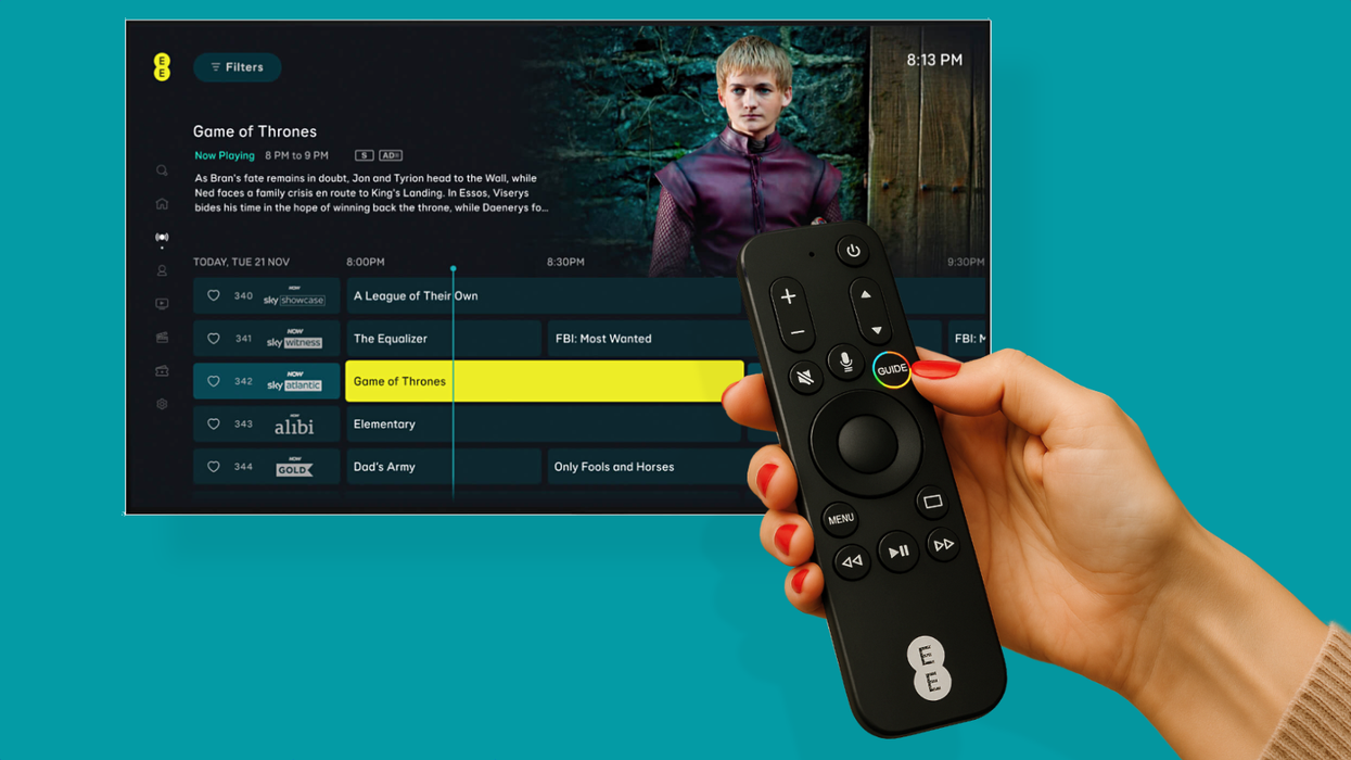 EE TV remote for the Apple TV held in a womans hand pointed at a flatscreen tv with the EE TV interface shown on-screen and a green background