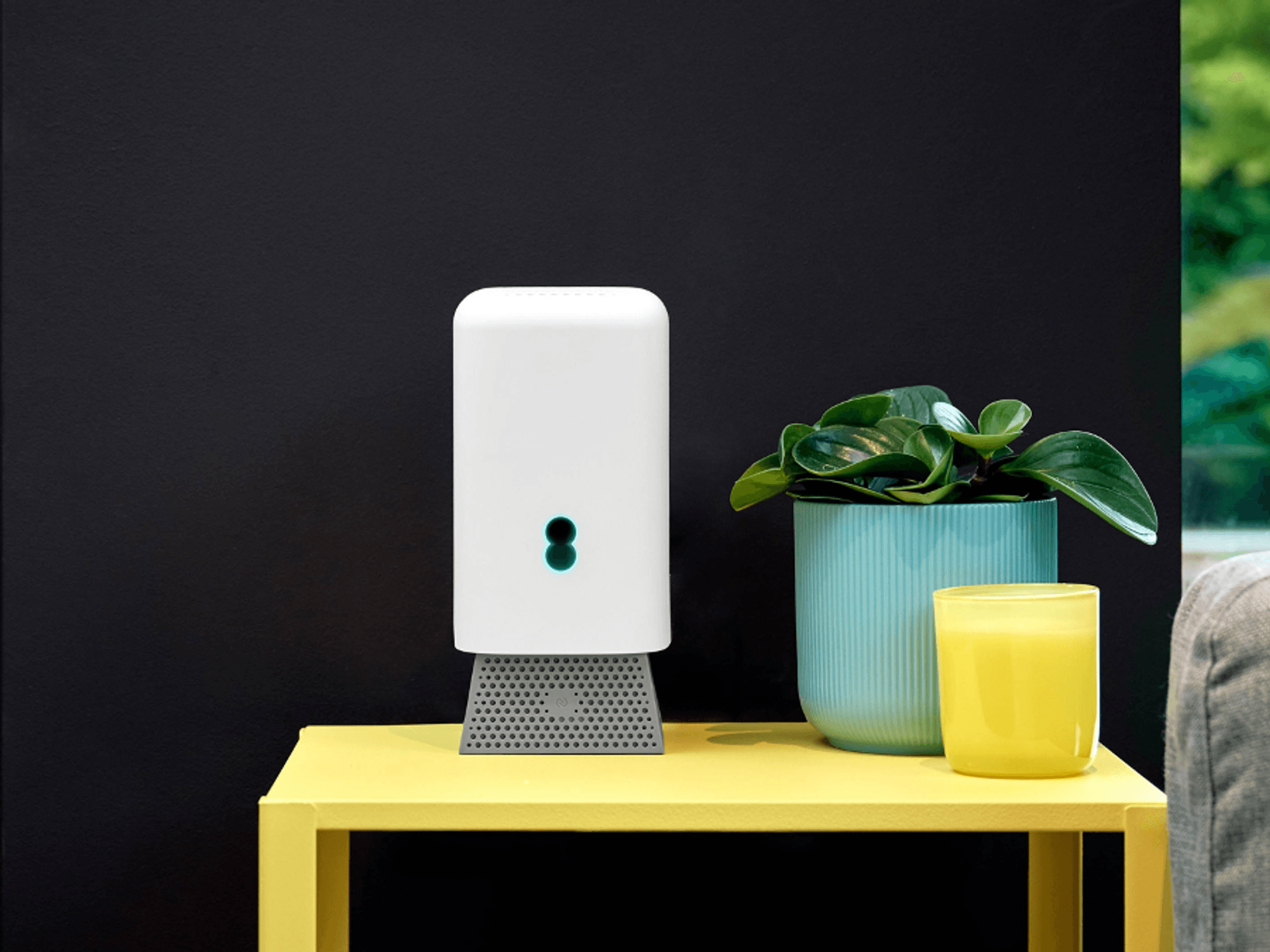 EE Wi-Fi 7 hub pictured on a yellow table in a house
