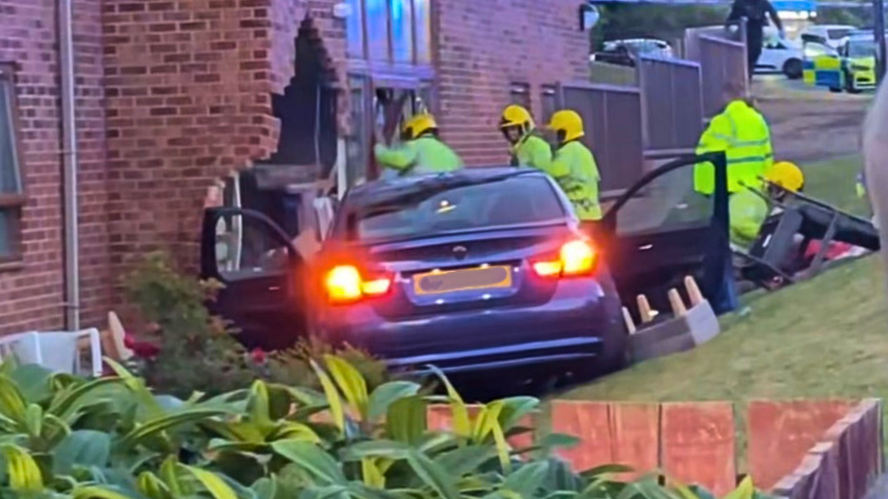 Eight people hospitalised after 'stolen BMW' crashes into care home as two men arrested