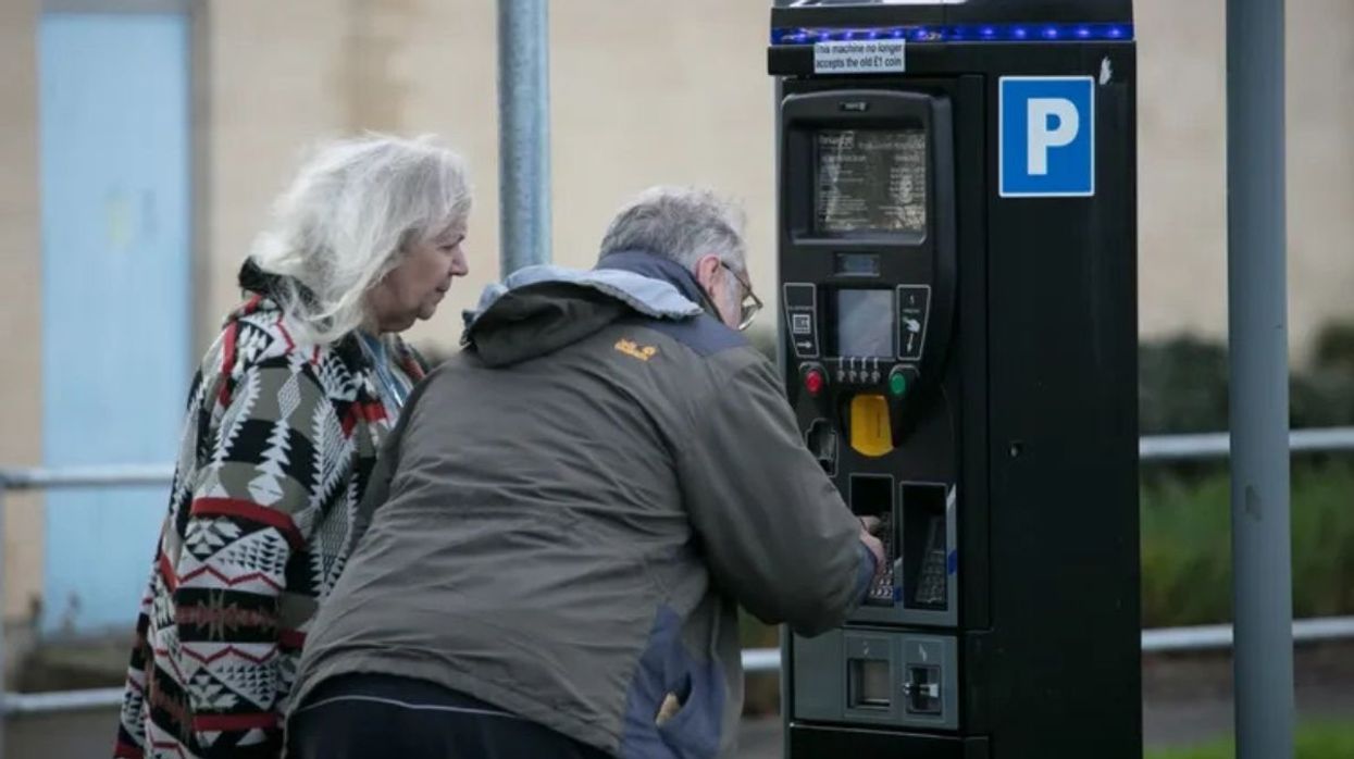 Elderly couple paying for parking
