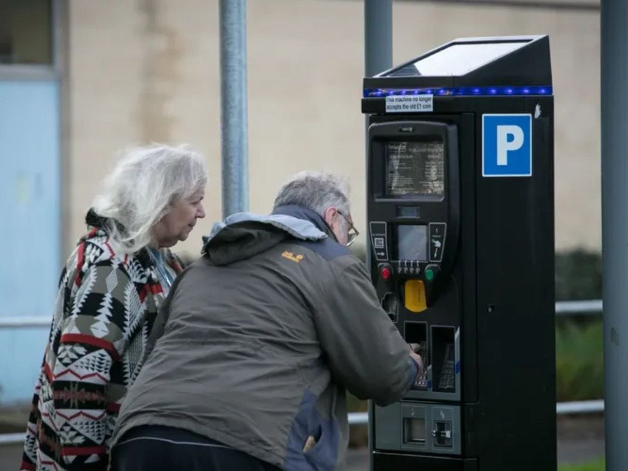 Elderly couple paying for parking