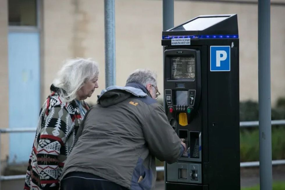 Elderly couple paying for parking