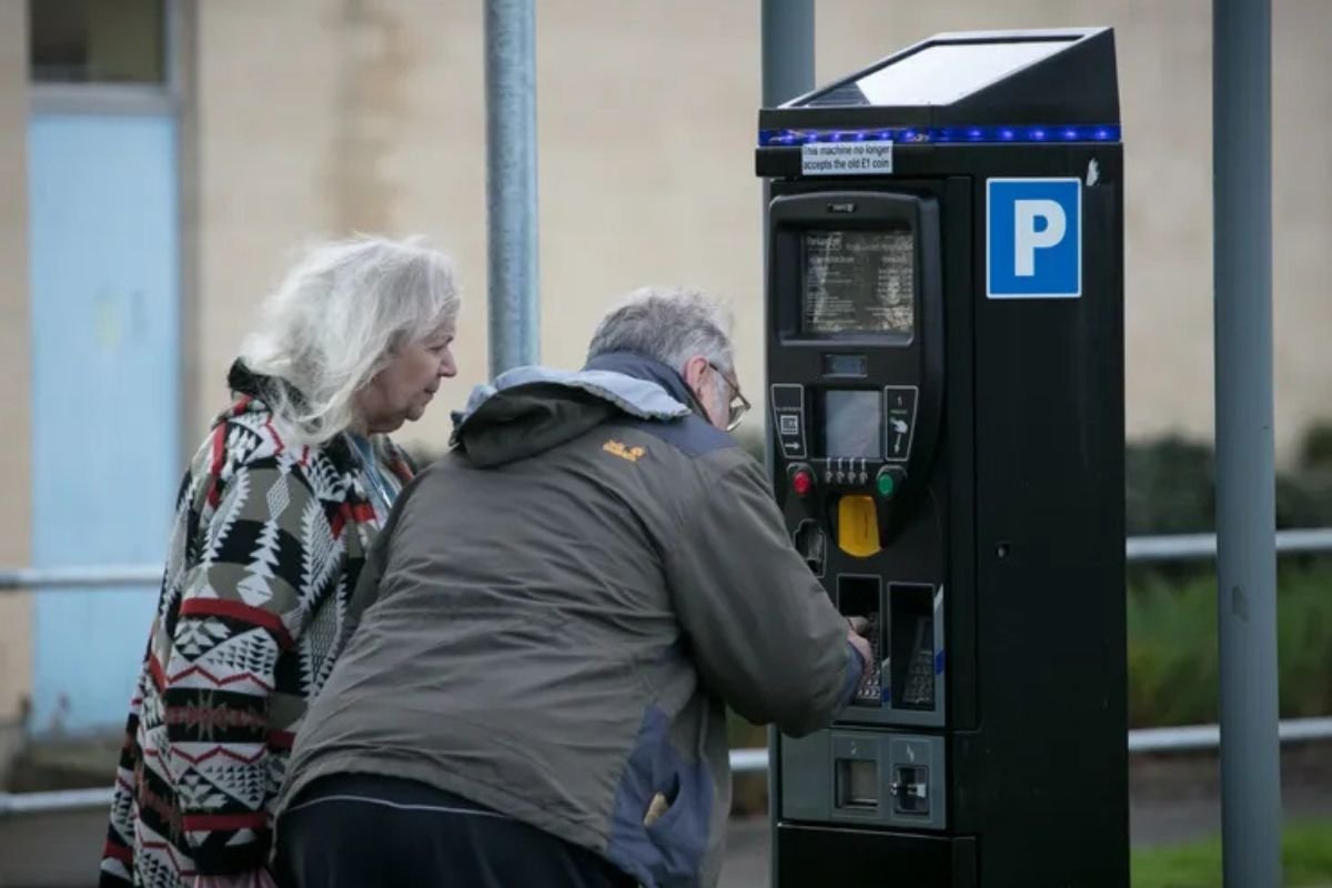 Elderly couple paying for parking
