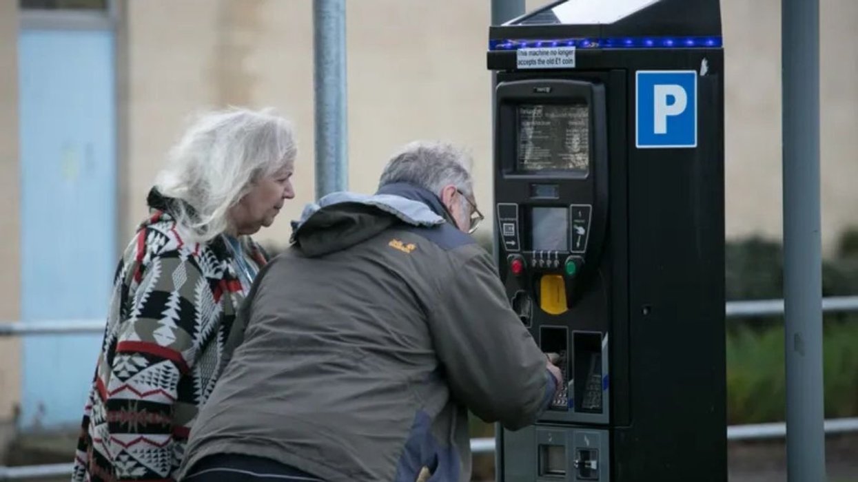 Elderly couple paying for parking