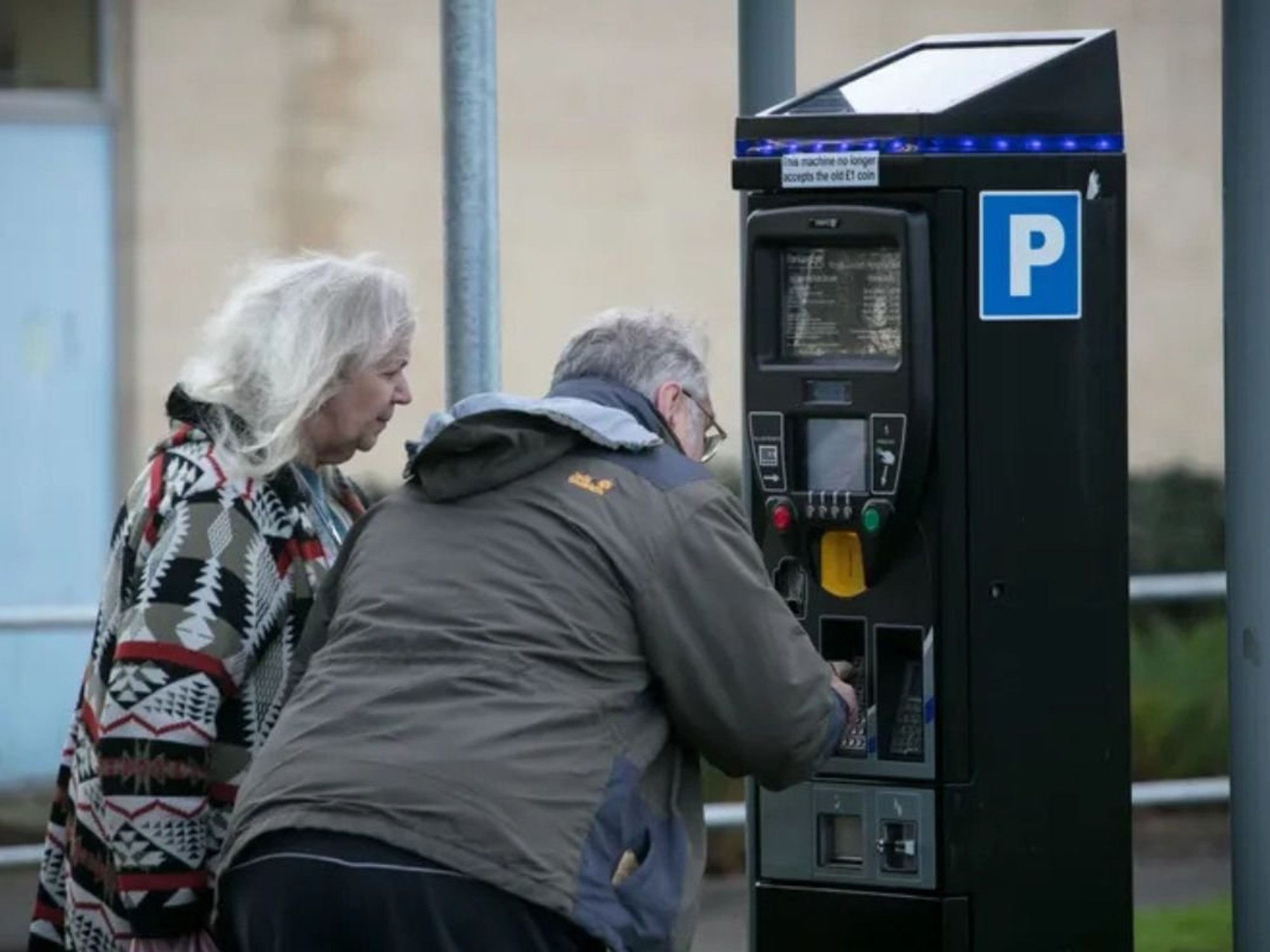 Elderly couple paying for parking