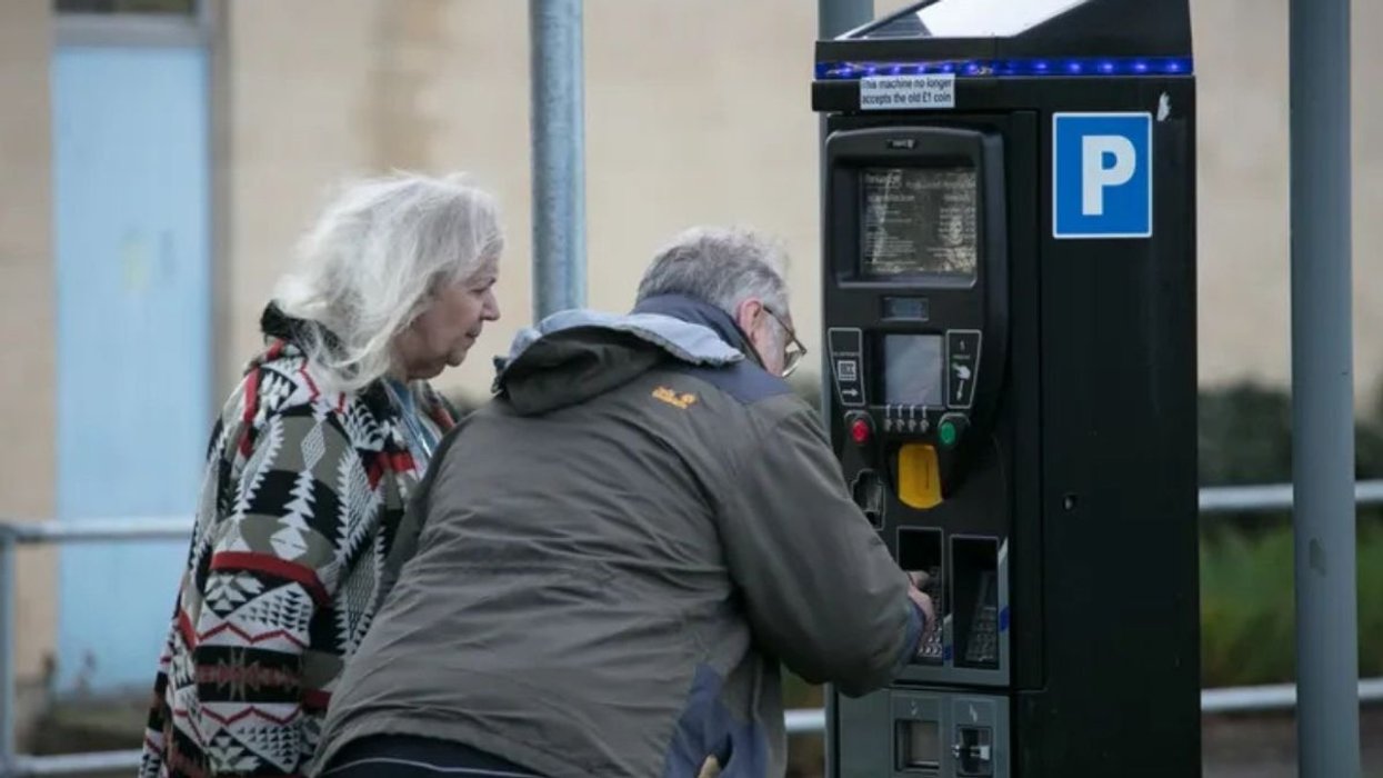 Elderly couple paying for parking