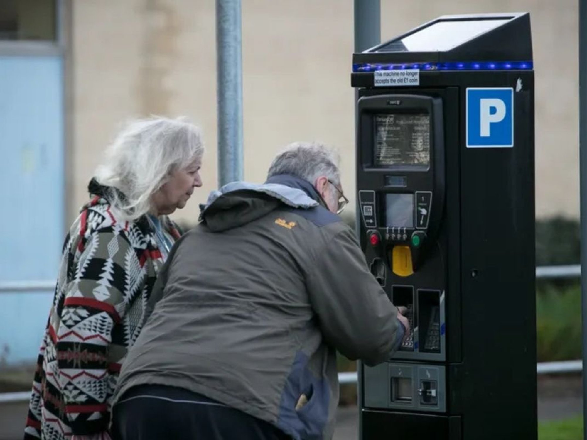 Elderly couple paying for parking