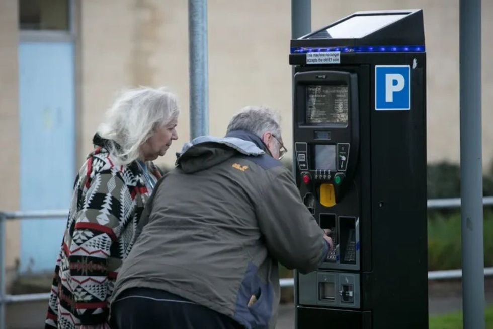Elderly couple paying for parking