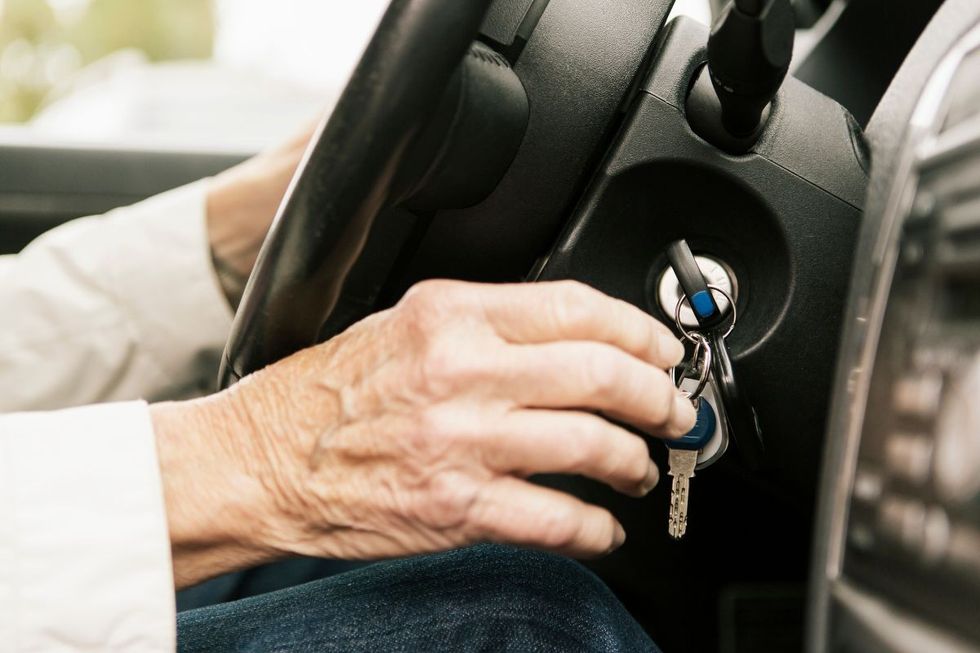 Elderly hand touching car keys