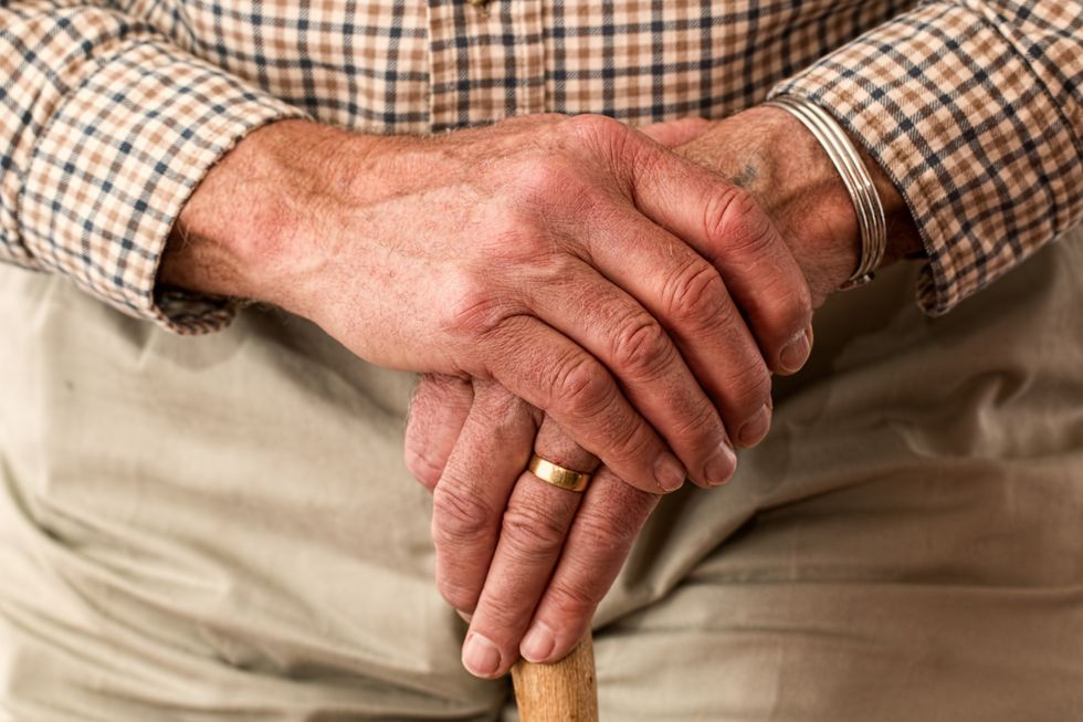 Elderly man holding a stick