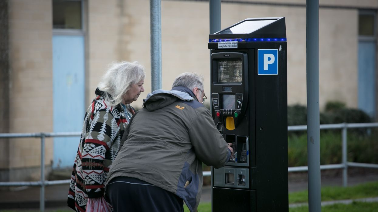 Elderly people paying for parking