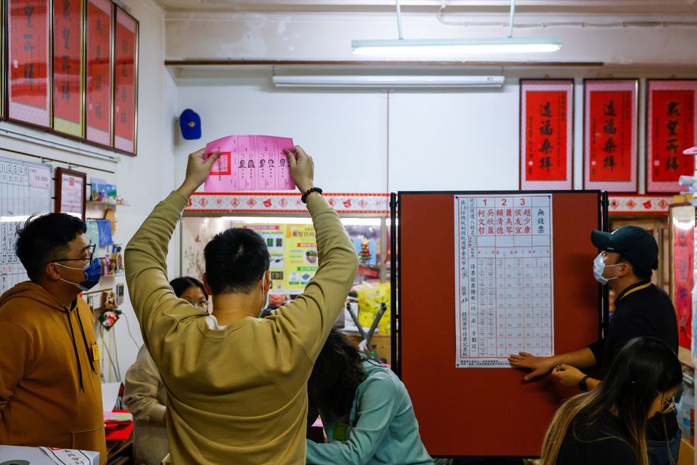 Election workers count ballots at a polling station during the presidential and parliamentary elections in Taipei