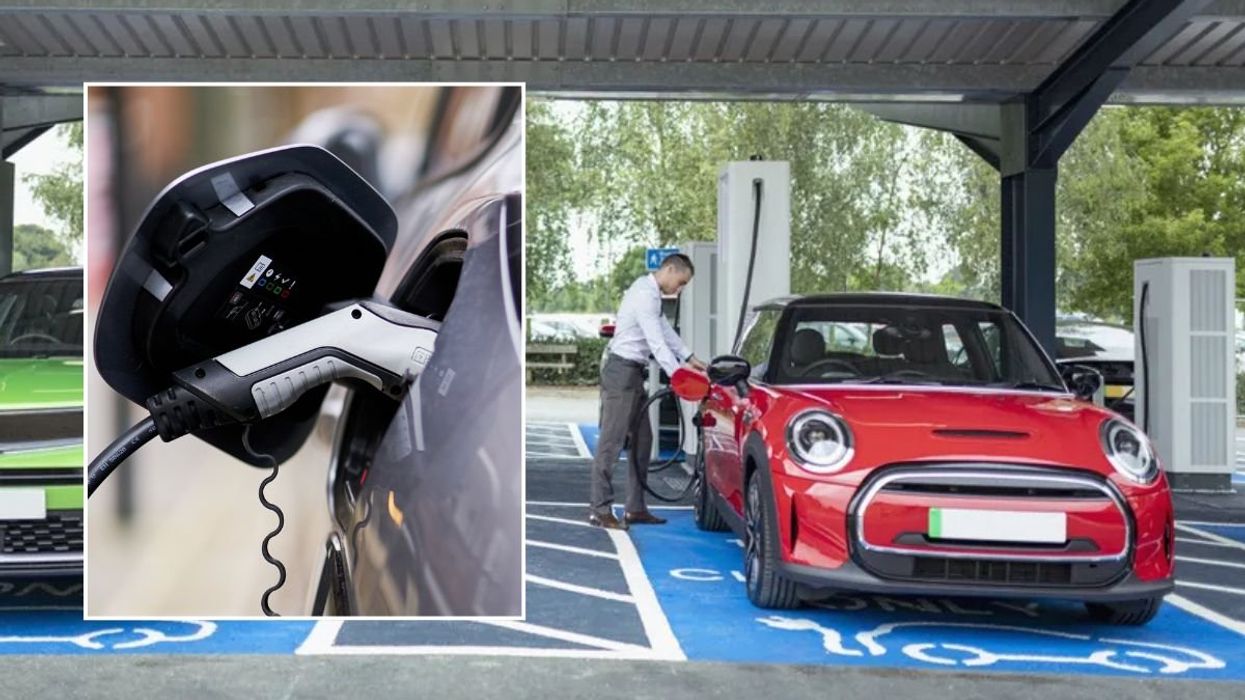 Electric car charger and a man charging an electric car