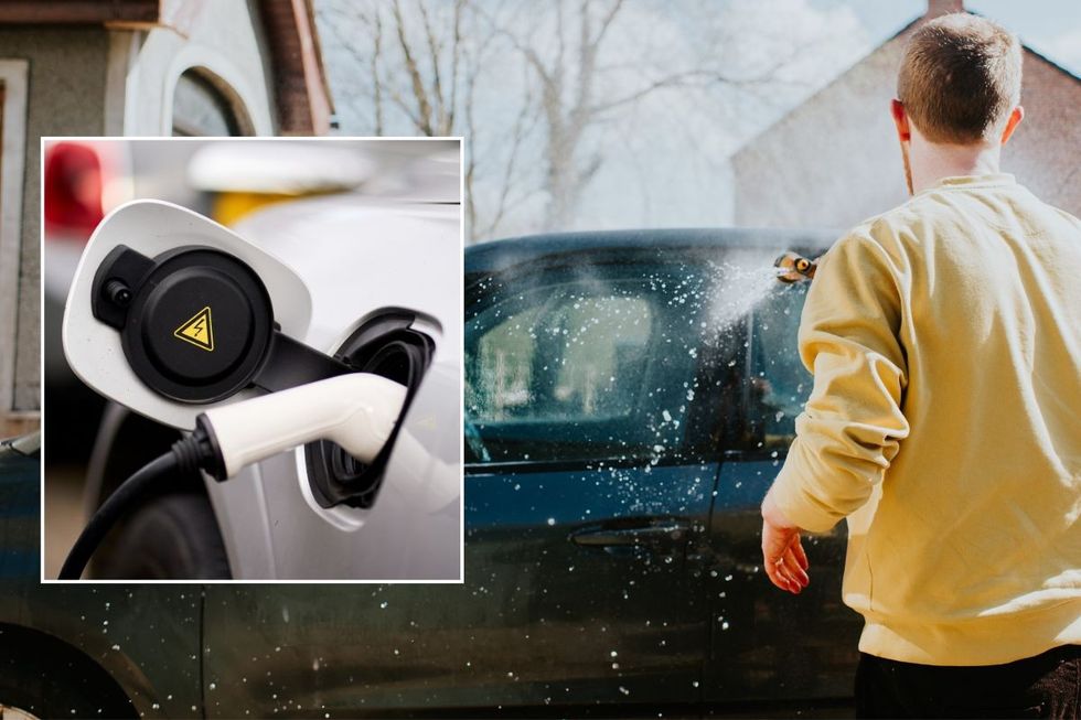 Electric car charging and a man washing his car