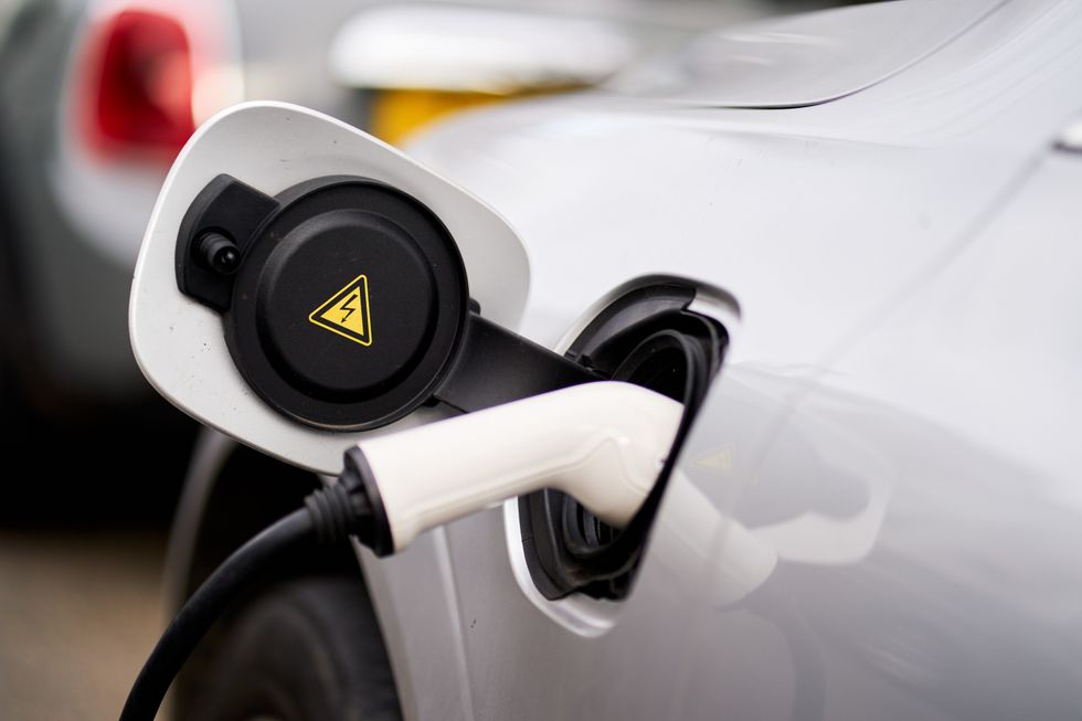 electric vehicle charger on white car
