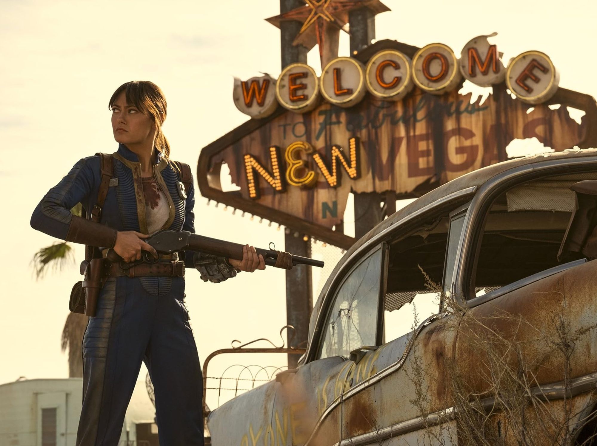 Ella Purnell pictured outside the Welcome To New Vegas sign from Fallout season 2