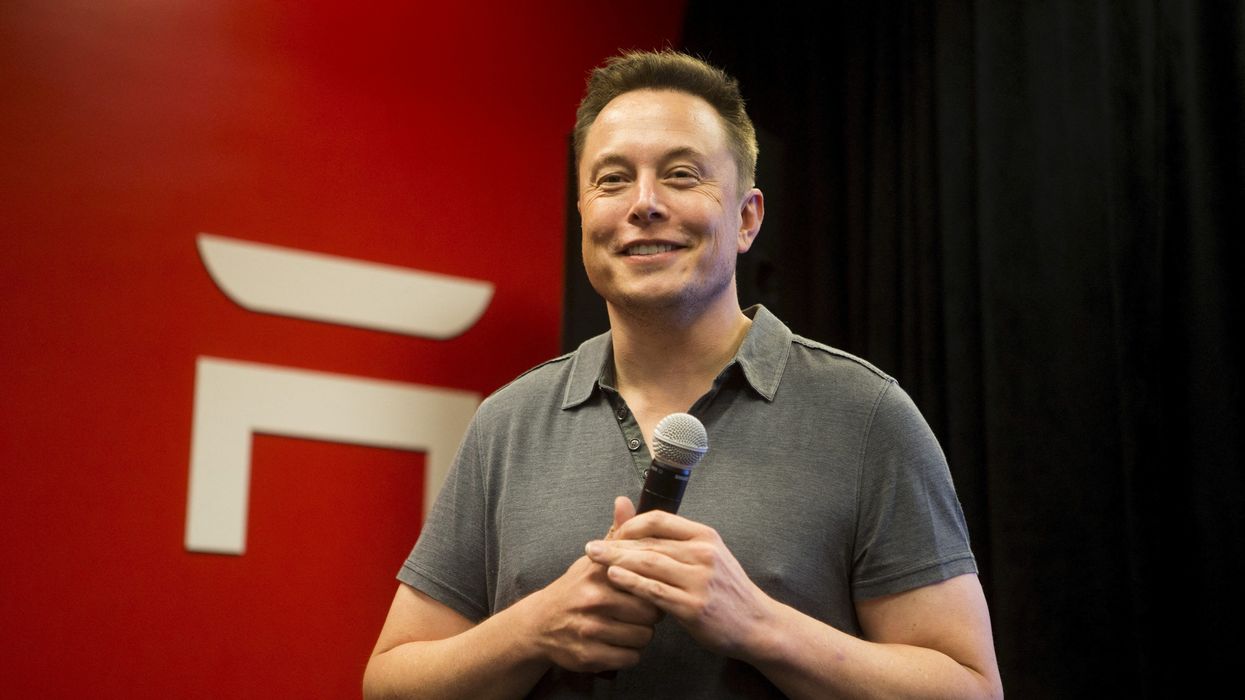 Elon Musk speaking at a Tesla event