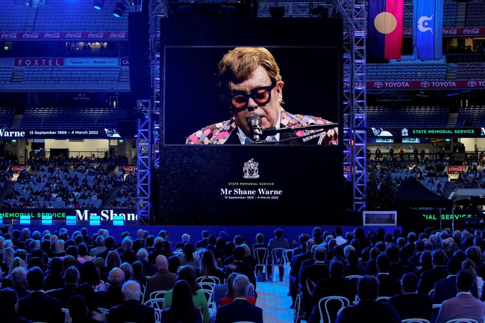 Elton John performs via video link at a state memorial service for Australian cricketer Shane Warne at the Melbourne Cricket Ground, Australia March 30, 2022. REUTERS/Sandra Sanders