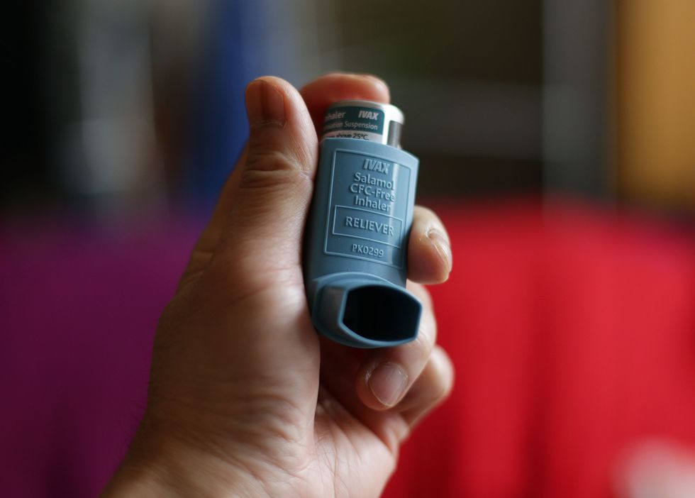 EMBARGOED TO 0001 FRIDAY MAY 13 File photo dated 07/01/15 of a person holding an Ivax Reliever inhaler for the treatment of asthma, as rising pollen levels this weekend could leave people with asthma at risk of life-threatening asthma attacks, Asthma and Lung UK has warned.