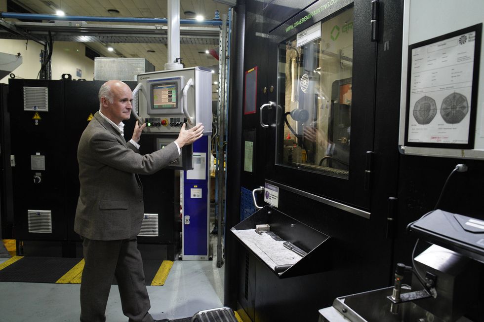 EMBARGOED TO 0001 FRIDAY OCTOBER 28 EDITORIAL USE ONLY Artist Martin Jennings prepares the first coins featuring the portrait of King Charles III to be struck at The royal Mint in Pontyclun, ahead of them entering circulation from December 28, 2022. Issue date: Friday October 28, 2022.