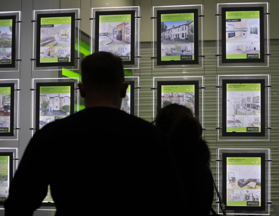 EMBARGOED TO 0001 MONDAY MARCH 21 File photo dated 18/12/16 of people looking at homes for sale in an estate agents window. The average price tag on a home in Britain has topped 350,000 for the first time, according to website Rightmove.