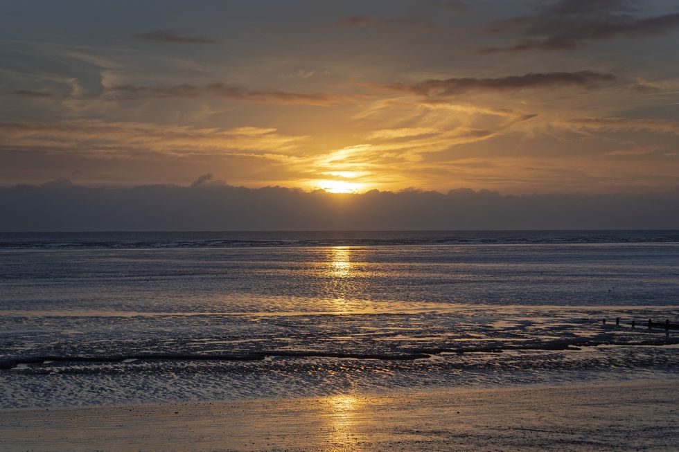 EMBARGOED TO 0001 MONDAY MAY 16 File photo dated 09/01/19 of the sun rises over the English Channel viewed from Littlestone beach in Kent. One in five (20%) 18 to 25-year-olds have experienced holiday scams or know someone who has, a survey has found. Issue date: Monday May 16, 2022.