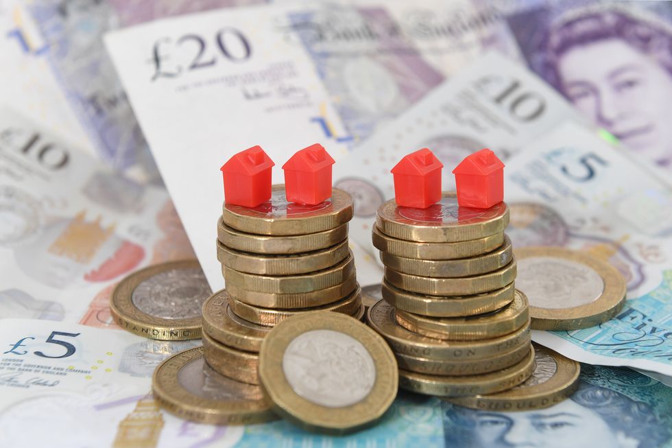 EMBARGOED TO 0001 MONDAY MAY 9 File photo dated 12/09/18 of model houses on a pile of coins and bank notes. Turning to the %22Bank of Mum and Dad%22 could become %22more common%22 as the cost-of-living crisis mounts, an expert has said. Lawyer Grant Johnson said rising bills could mean that increasing numbers of parents %22want or need to give their children money%22. Issue date: Friday May 6, 2022.