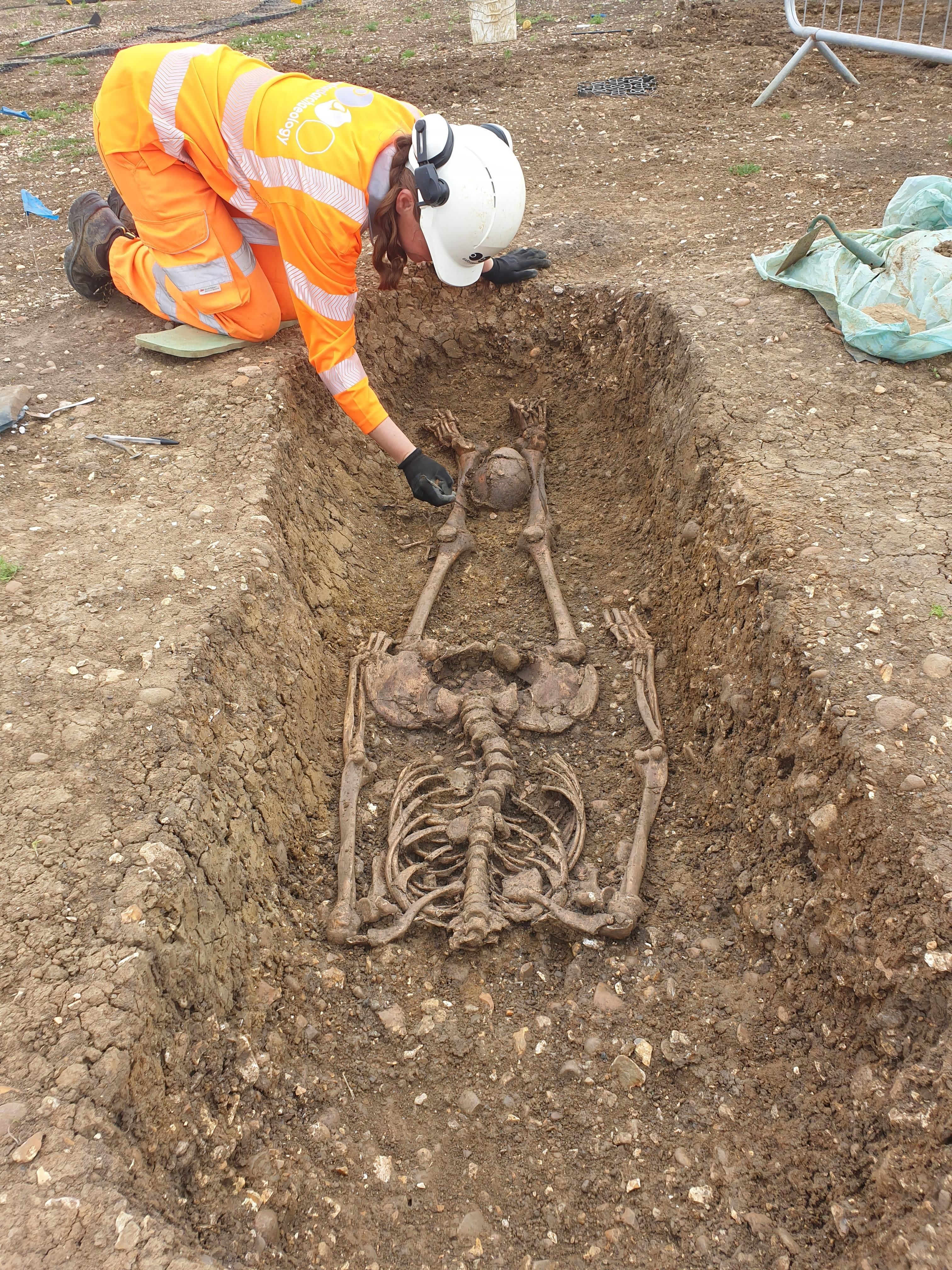 EMBARGOED TO 0001 SATURDAY FEBRUARY 5 Undated handout photo issued by HS2 of a Roman skeleton with head placed between legs that was found at an HS2 archaeological dig near Aylebury, Buckinghamshire. Around 40 beheaded skeletons are among 425 bodies exhumed by HS2 archaeologists in a large Roman cemetery discovered on the route of the high-speed railway. The 50-strong team uncovered the remains at a cemetery in Fleet Marston near Aylesbury, Buckinghamshire, HS2 Ltd said. Issue date: Saturday February 5, 2022.