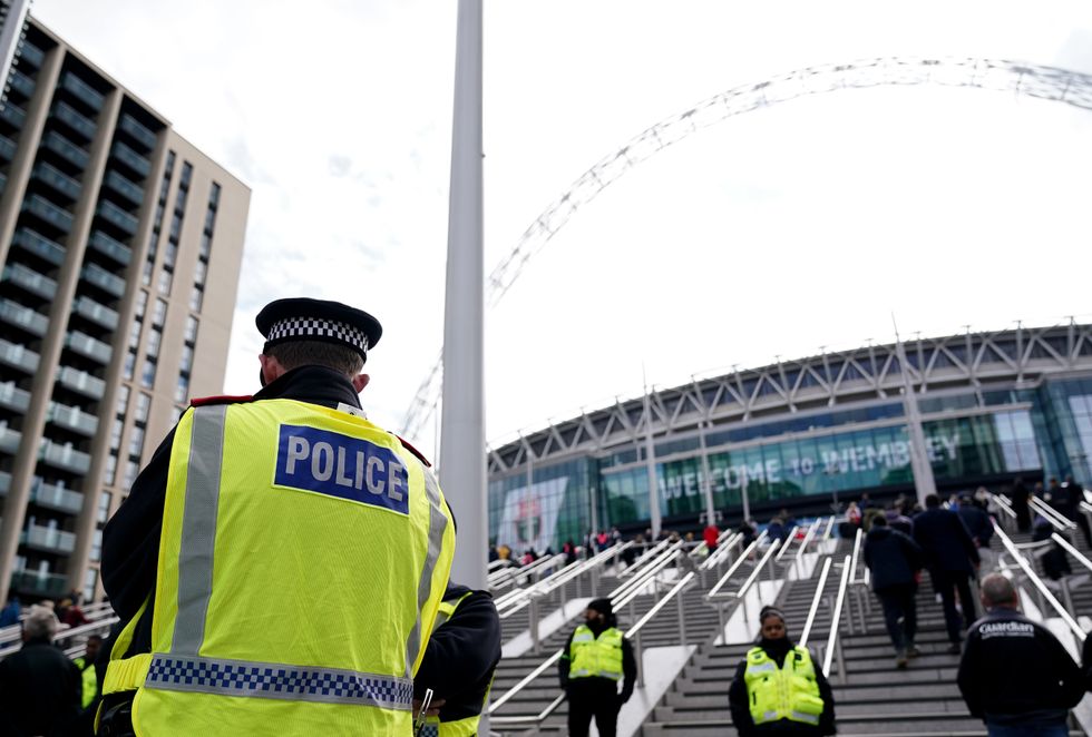 EMBARGOED TO 0001 SATURDAY NOVEMBER 5 File photo dated 03/04/22 of a Police officer outside Wembley Stadium, London, as fans convicted of taking, selling or in possession of Class A drugs at football matches will be issued with banning orders from next week.