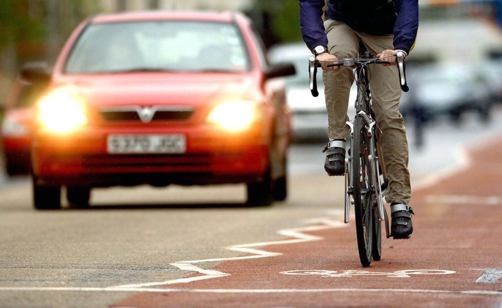 EMBARGOED TO 0001 THURSDAY DECEMBER 30 Undated file photo of a a cyclist using a cycle lane alongside heavy traffic in Cambridge. Major changes to the Highway Code risk being ineffective due to not being widely promoted, road safety campaigners have warned. Charity Cycling UK told the PA news agency that a %22long-term and well-funded communications campaign%22 is needed to make people aware of the updates. Issue date: Thursday December 30, 2021.