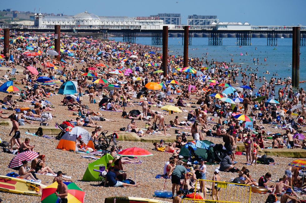 EMBARGOED TO 0001 THURSDAY NOVEMBER 25 File photo dated 18/07/21 of people enjoying the hot weather on Brighton beach. According to a new study, older people and younger adults are at a higher risk of needing emergency care when extreme heat hits.