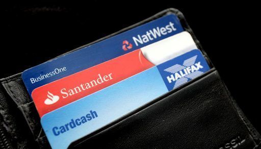 EMBARGOED TO 0001 THURSDAY SEPTEMBER 29 File photo dated 03/09/13 of a general view of a Halifax, Santander and NatWest bank cards in a wallet, as banks and building societies will have stronger incentives to prevent scams happening in the first place, as well as having to reimburse victims who have been tricked into transferring money to a fraudster, under a regulator's proposals.