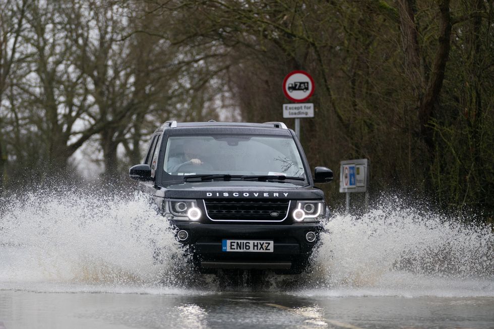 EMBARGOED TO 0001 TUESDAY DECEMBER 6 File photo dated 21/02/22 of a car travelling along a flooded road in Mountsorrel in Leicestershire, as more than one in six motorists (18%) admit they would not change their driving plans despite a red weather warning, a new survey suggests.
