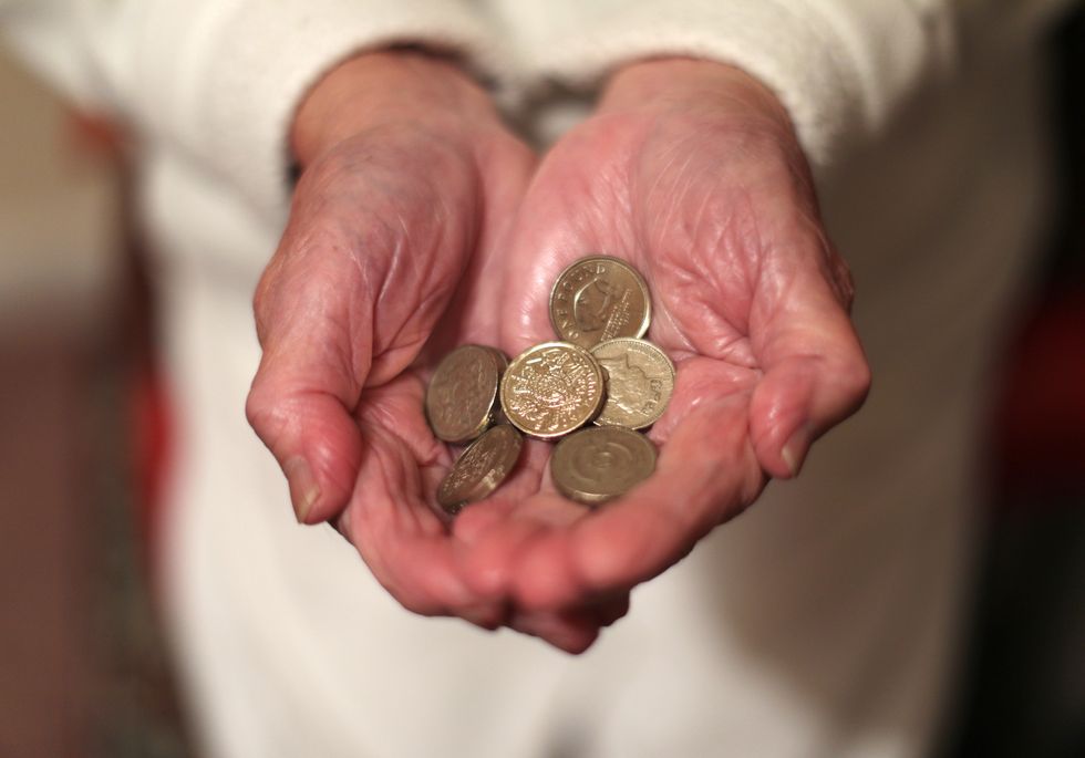 EMBARGOED TO 0001 WEDNESDAY DECEMBER 7 File photo dated 22/12/16 of an elderly woman holding pound coins in her hands, in Poole, Dorset. Pensioners on low incomes are being urged by Age UK to see if they qualify for Pension Credit, which could help them to access other cost-of-living support as well as topping up their regular income. Issue date: Wednesday December 7, 2022.