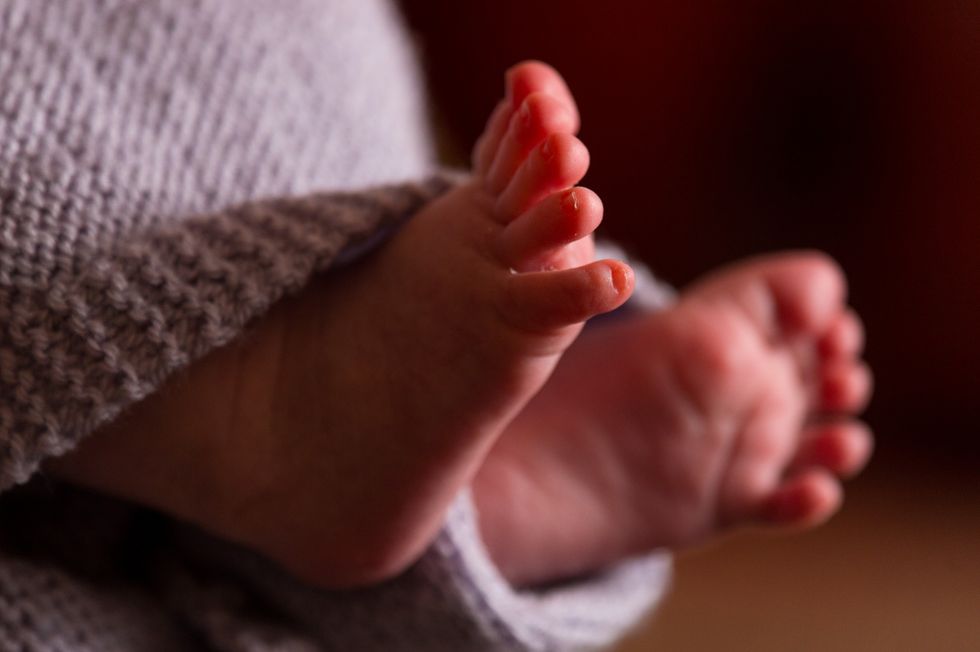 EMBARGOED TO 0001 WEDNESDAY JULY 27 File photo dated 23/01/16 of the feet of a new baby wrapped in a blanket, as trans men should be supported to chest-feed their babies should they choose to do so, a Royal College has said.