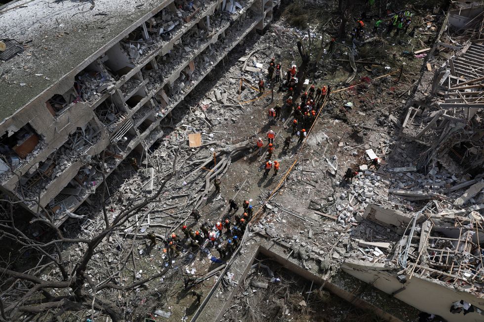 Emergency personnel work at an impact site following a missile attack from Iran on Israel, amid the Iran-Israel conflict