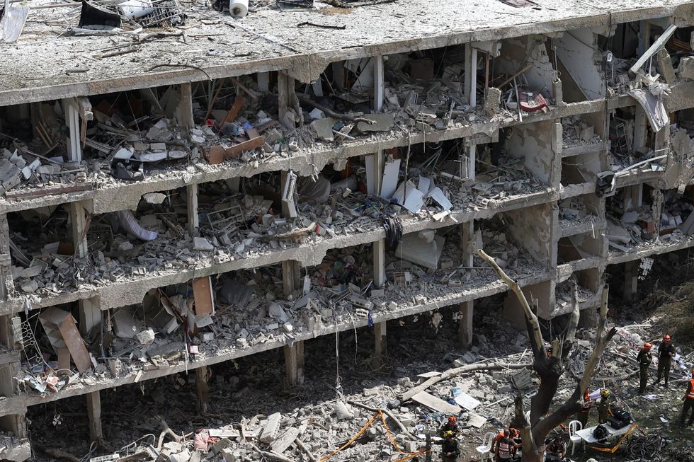 Emergency personnel work at an impact site in Tel Aviv following a missile attack from Iran