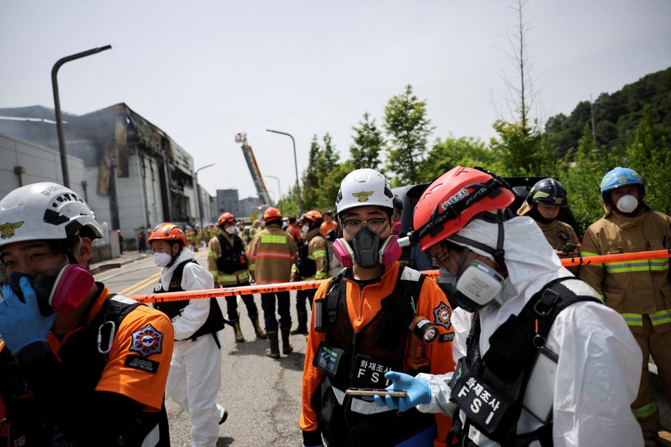 Emergency personnel work at the site of a deadly fire at a lithium battery factory