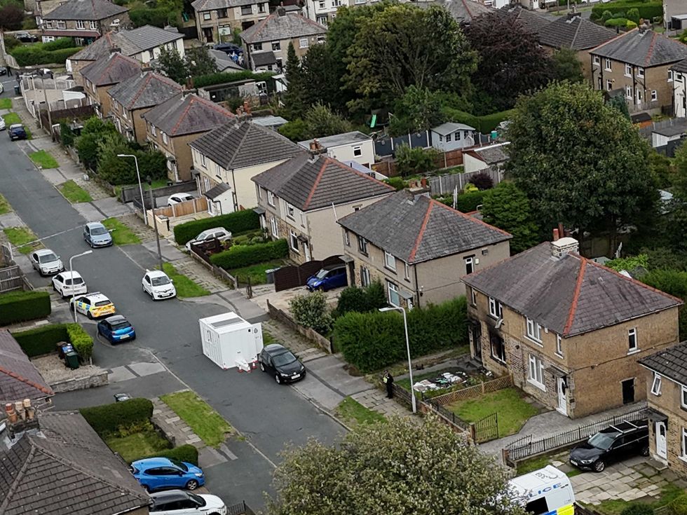 Emergency services in Westbury Road, Bradford, following a house fire where four people, including three children, died
