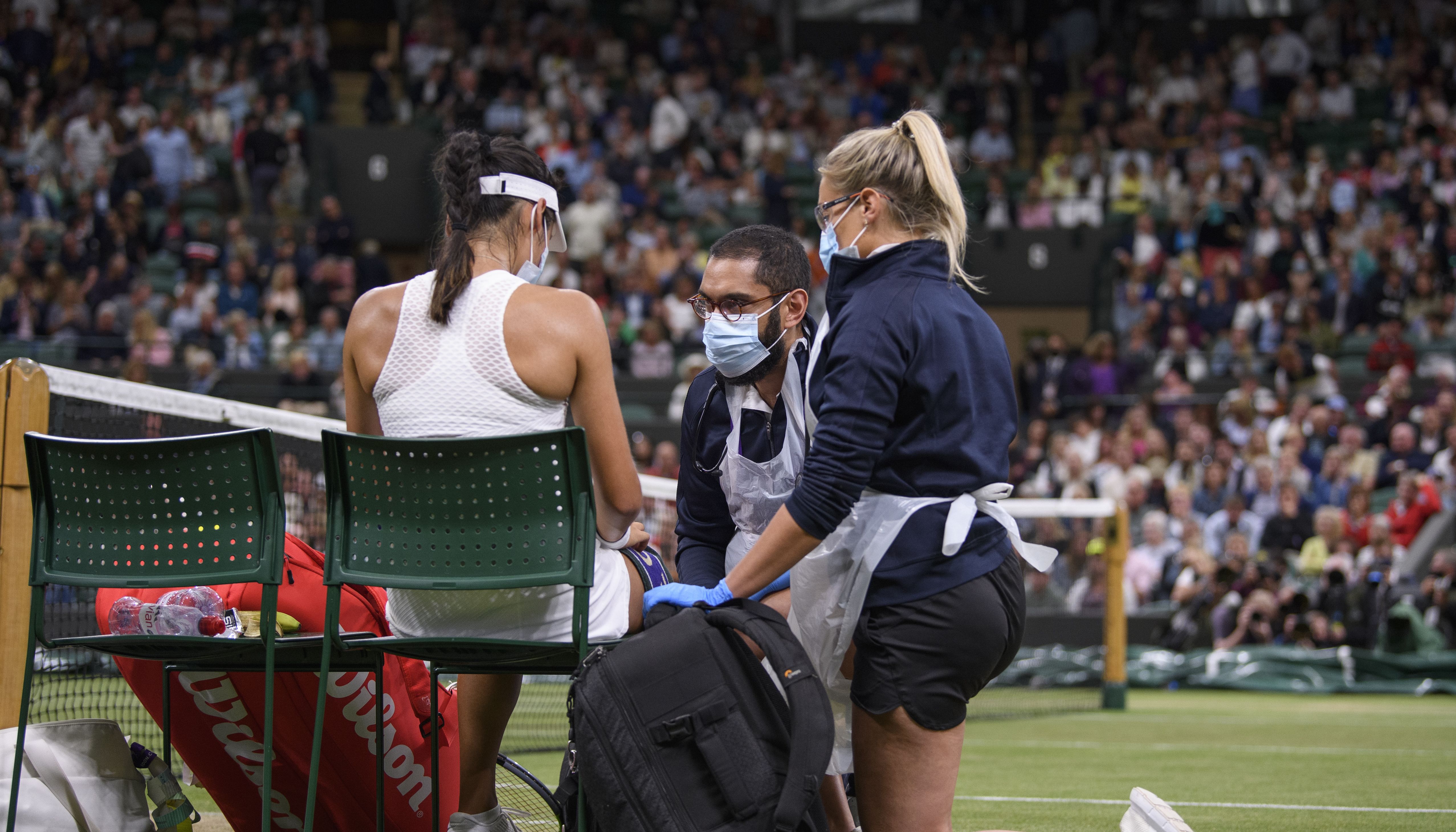 Emma Raducanu receives treatment during a medical time out in the match against Ajla Tomljanovic on day seven of Wimbledon