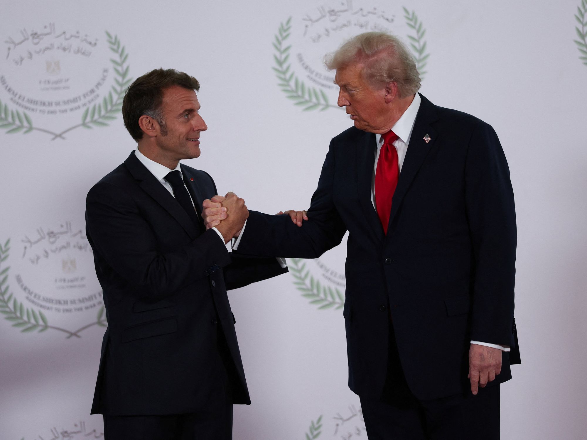Emmanuel Macron and Donald Trump shaking hands in Egypt