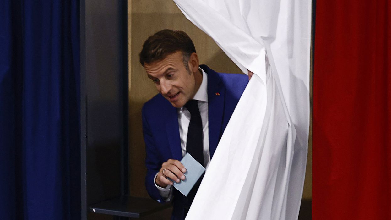 Emmanuel Macron leaves a voting booth, as he visits a polling station to vote in the first round of the early French parliamentary elections, in Le Touquet-Paris-Plage, France