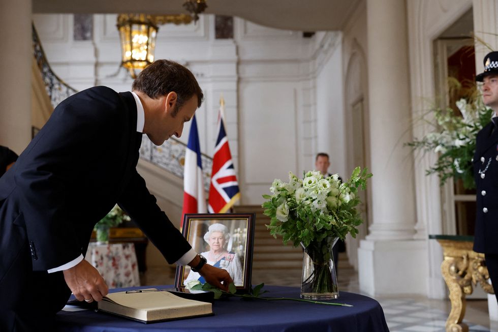 Emmanuel Macron signing Queen Elizabeth II's book of condolences